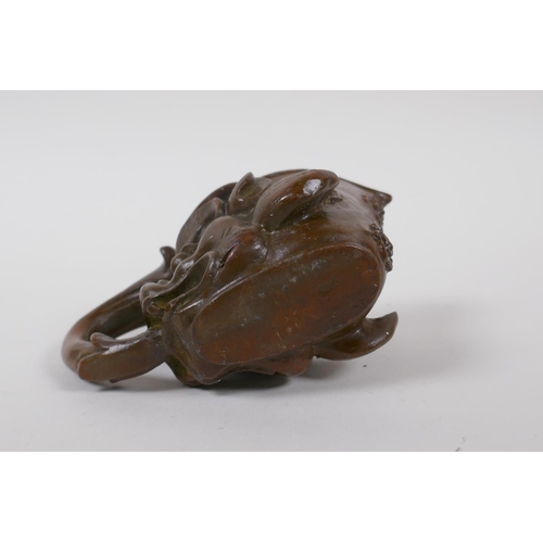 140 - A Chinese bronze libation cup with dragon head decoration, 8 cm high