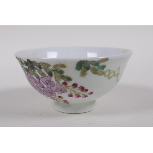 143 - A polychrome porcelain tea bowl with bird and flower decoration, character inscription verso, Chines... 