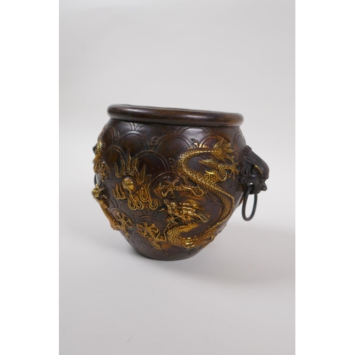 145 - A Chinese bronze censer with two lion mask handles, and raised gilt dragon decoration, 4 character m... 