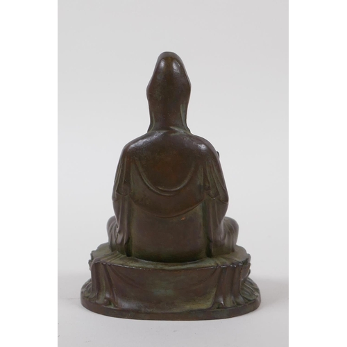 15 - A Chinese bronze of Quan Yin seated on a lotus flower throne, 10cm high