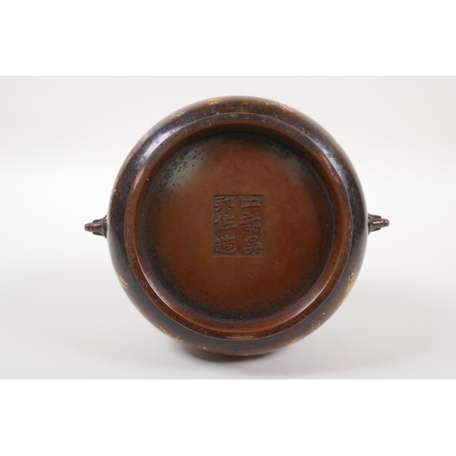 150 - A Chinese bronze censer with two mask handles and gilt patina, 6 character to base, 16cm diameter