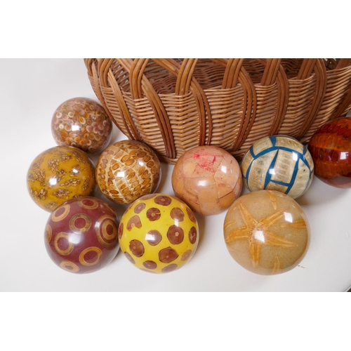 154 - A collection of vintage decorative specimen balls, containing seed pods, nuts, star fish etc, in a w... 