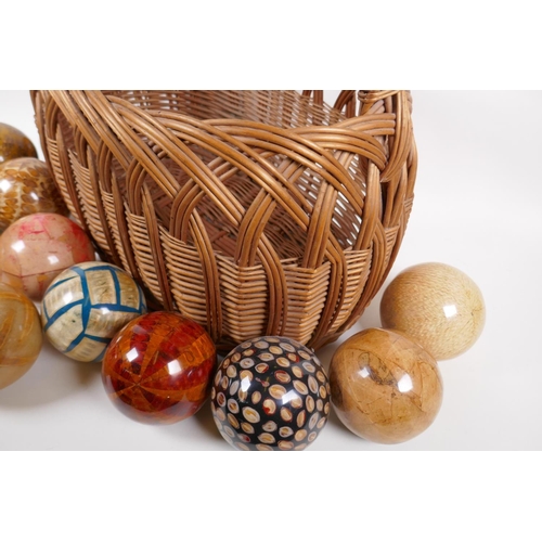 154 - A collection of vintage decorative specimen balls, containing seed pods, nuts, star fish etc, in a w... 