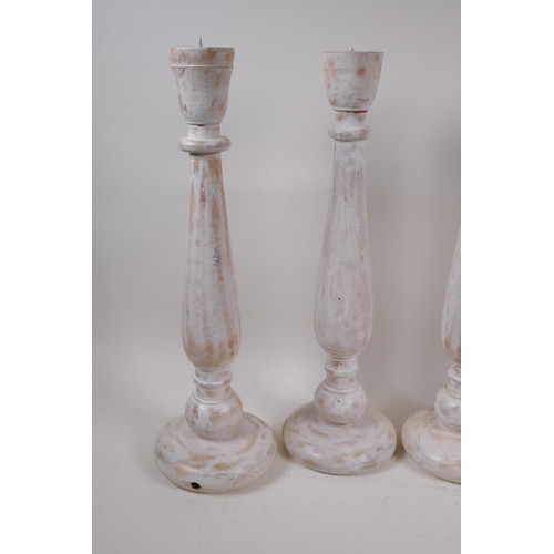 163 - Two pairs of painted and distressed pricket candlesticks, 46cm high