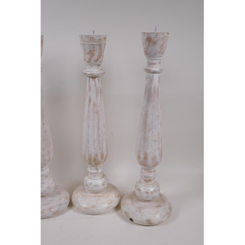 163 - Two pairs of painted and distressed pricket candlesticks, 46cm high