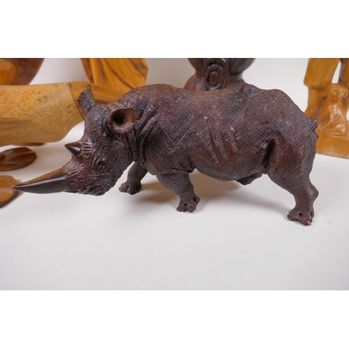 168 - A carved wood figure of a rhinoceros, 26cm long, AF, two carved wood ducks, male and female figures ... 