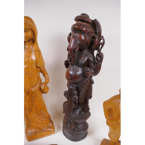 168 - A carved wood figure of a rhinoceros, 26cm long, AF, two carved wood ducks, male and female figures ... 