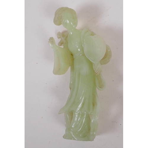 19 - A Chinese green hardstone figure of a girl with a lion, 15cm high