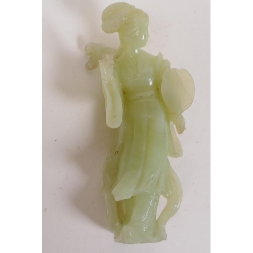 19 - A Chinese green hardstone figure of a girl with a lion, 15cm high