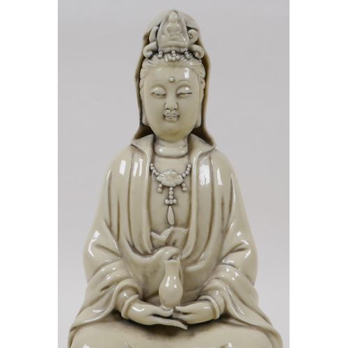 20 - A blanc de chine porcelain figure of Quan Yin seated on a lotus flower, impressed Chinese seal marks... 