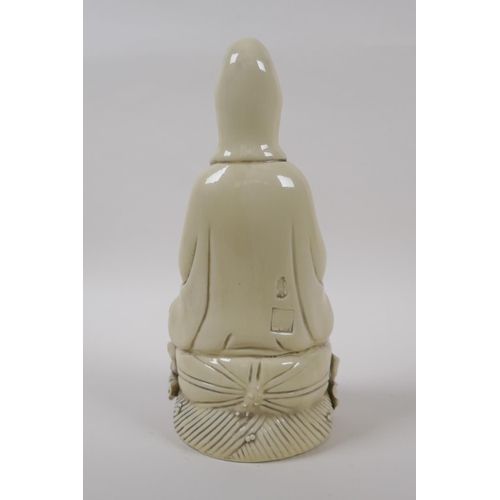 20 - A blanc de chine porcelain figure of Quan Yin seated on a lotus flower, impressed Chinese seal marks... 