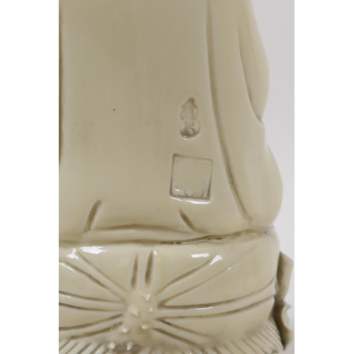 20 - A blanc de chine porcelain figure of Quan Yin seated on a lotus flower, impressed Chinese seal marks... 