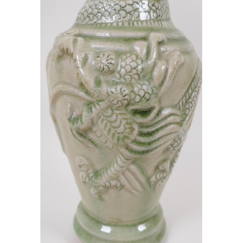 22 - An oriental celadon glazed porcelain vase, embossed with dragons (drilled), 30cm