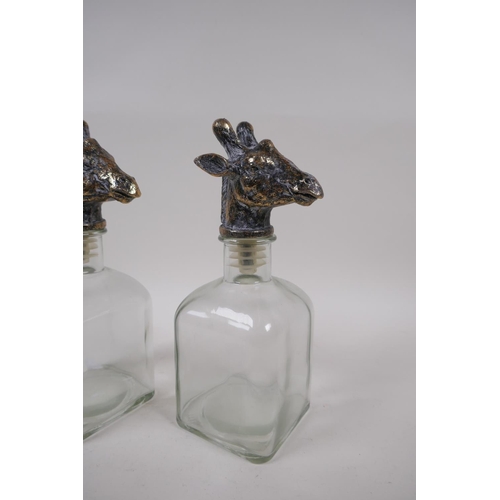 233 - A pair of contemporary glass decanters with gilt giraffe stoppers, 24cm high