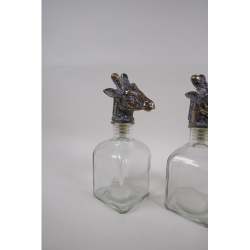 233 - A pair of contemporary glass decanters with gilt giraffe stoppers, 24cm high