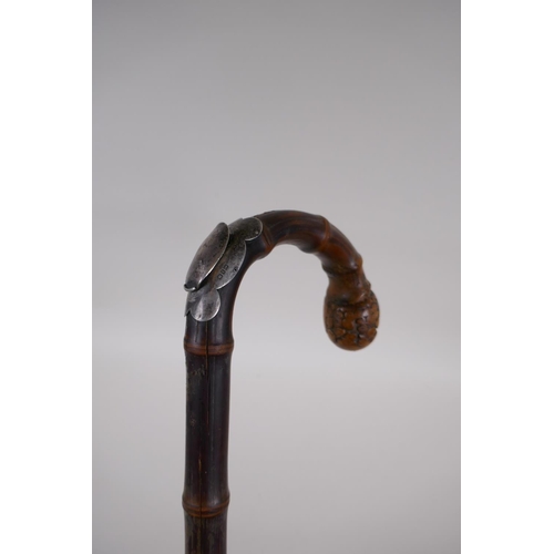 24 - A C19th bamboo walking stick with hallmarked silver mount (Birmingham, 1899) and concealed brass eje... 