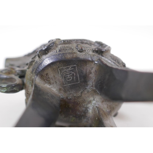 248 - A Chinese bronze Jue (wine vessel), with kylin handle and dragon decoration, 13cm high