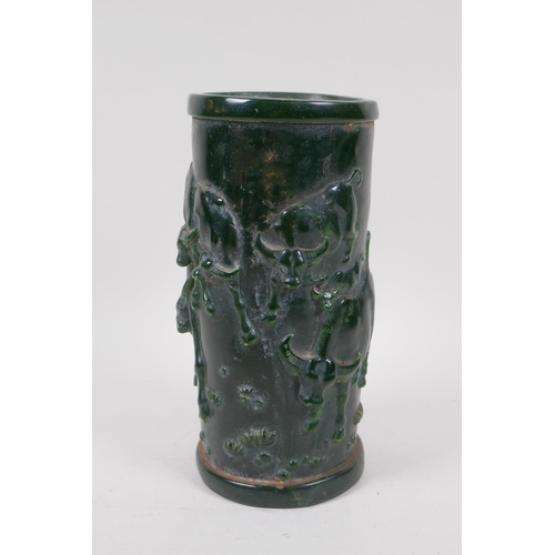 253 - A Chinese reconstituted green hardstone brush pot with raised buffalo decoration, mark to base, 20cm... 