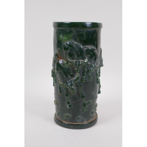 253 - A Chinese reconstituted green hardstone brush pot with raised buffalo decoration, mark to base, 20cm... 