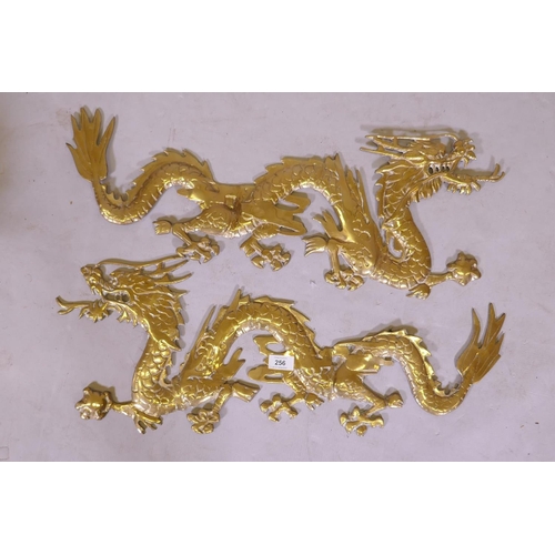 256 - A pair of brass mounts in the form of Chinese dragons, 70cm long