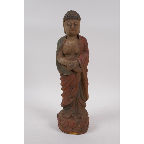 258 - A Chinese carved and painted wood figure of Buddha, 30cm high