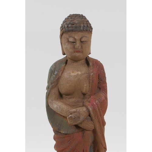 258 - A Chinese carved and painted wood figure of Buddha, 30cm high