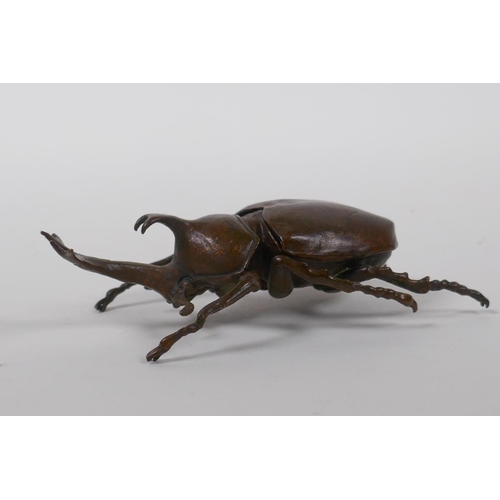 28 - A Japanese Jizai style bronze okimono in the form of a Japanese rhinoceros beetle, 10cm long