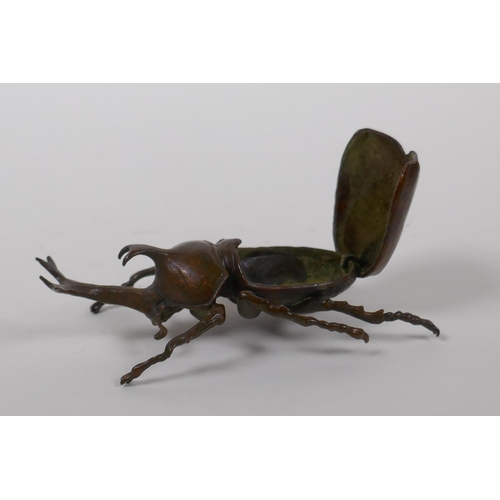 28 - A Japanese Jizai style bronze okimono in the form of a Japanese rhinoceros beetle, 10cm long