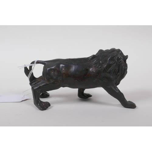 32 - A filled bronze of a lion, 14cm long