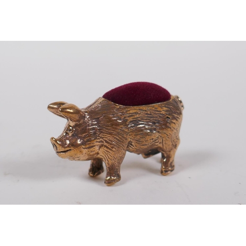 36 - A miniature copper pig pin cushion, 4 cm long