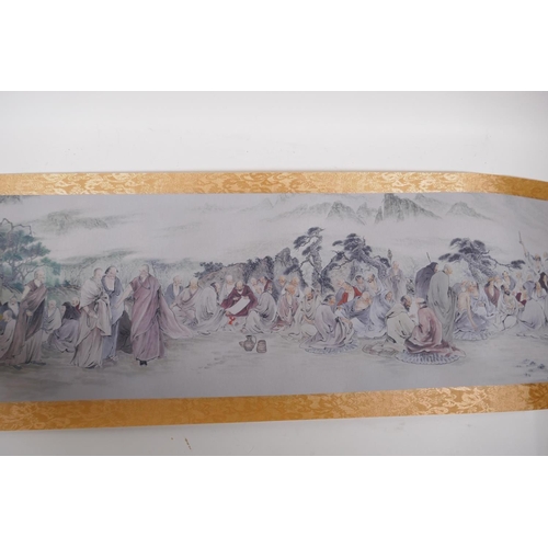 38 - A Chinese printed watercolour scroll depicting an extensive scene with many seated Lohan in conversa... 