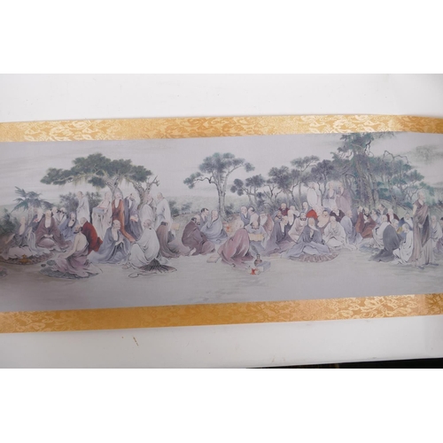 38 - A Chinese printed watercolour scroll depicting an extensive scene with many seated Lohan in conversa... 