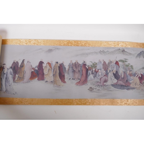 38 - A Chinese printed watercolour scroll depicting an extensive scene with many seated Lohan in conversa... 