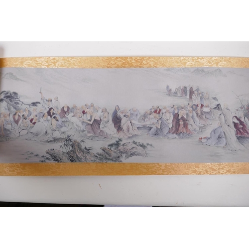 38 - A Chinese printed watercolour scroll depicting an extensive scene with many seated Lohan in conversa... 