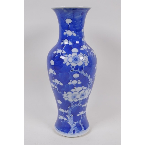 49 - A Chinese KangXi pottery blue and white vase decorated with prunus blossom on a cracked ice ground, ... 