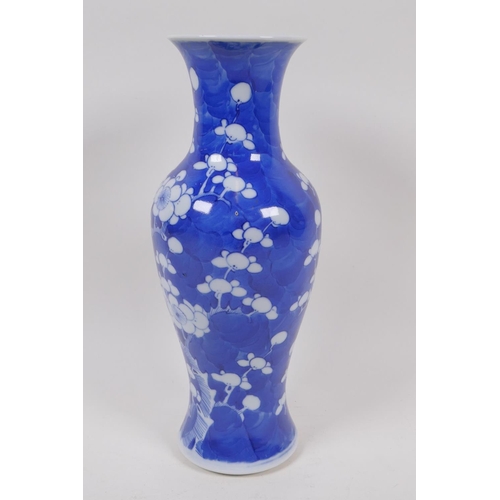 49 - A Chinese KangXi pottery blue and white vase decorated with prunus blossom on a cracked ice ground, ... 