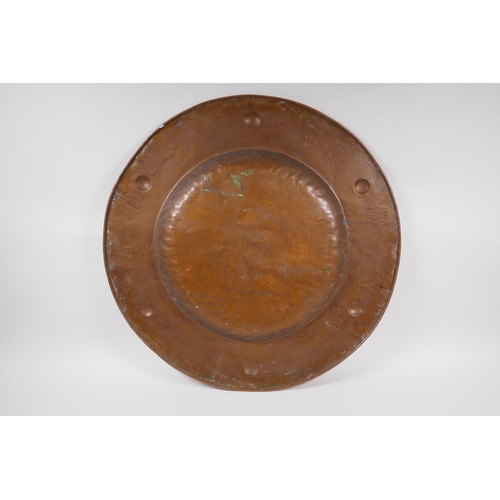 57 - An antique copper Newlyn style charger, 57cm diameter