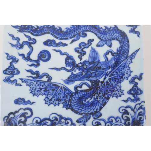 58 - A Chinese blue and white porcelain temple tile decorated with a dragon in flight, 20cm x 20cm