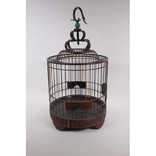 6 - A Chinese bird cage with carved decorative frieze depicting birds and squirrels amongst foliage, ben... 