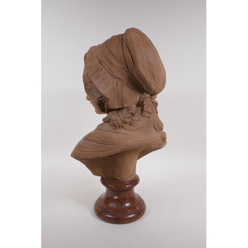 62 - A C19th terracotta bust of a young girl in a bonnet, mounted on a marble socle, 46cm high