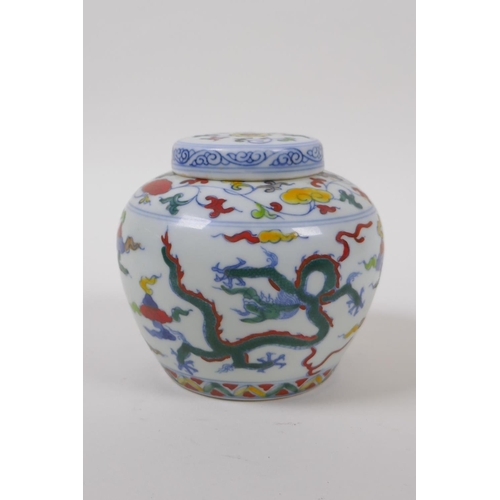 63 - A Chinese Wucai porcelain ginger jar and cover decorated with dragons in flight, character mark to b... 