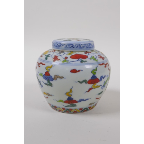 63 - A Chinese Wucai porcelain ginger jar and cover decorated with dragons in flight, character mark to b... 