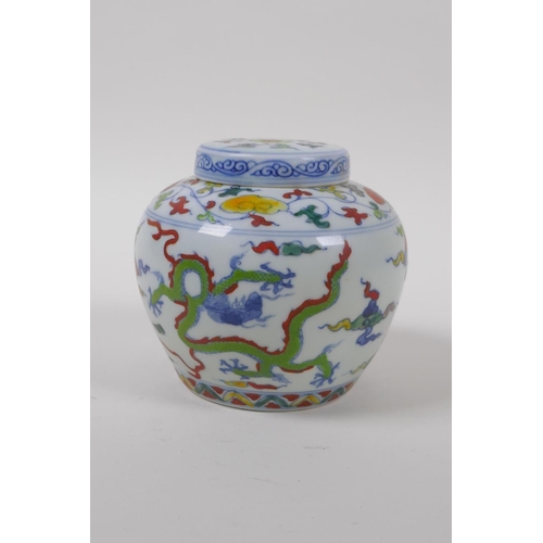 63 - A Chinese Wucai porcelain ginger jar and cover decorated with dragons in flight, character mark to b... 