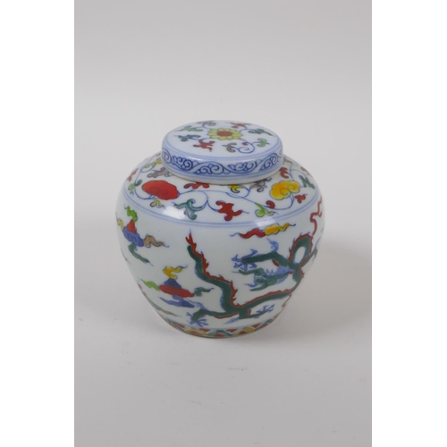 63 - A Chinese Wucai porcelain ginger jar and cover decorated with dragons in flight, character mark to b... 