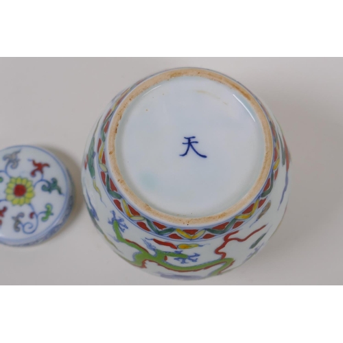 63 - A Chinese Wucai porcelain ginger jar and cover decorated with dragons in flight, character mark to b... 