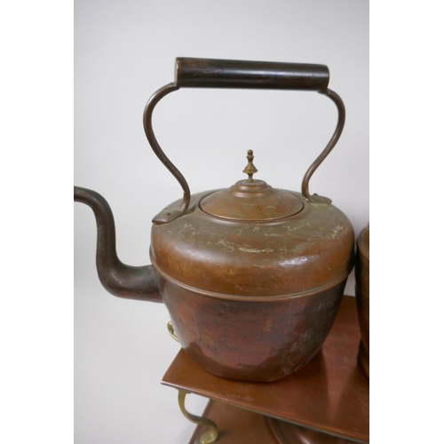 8 - A vintage brass and copper warming stand, 42cm wide, and two C19th copper and brass kettles