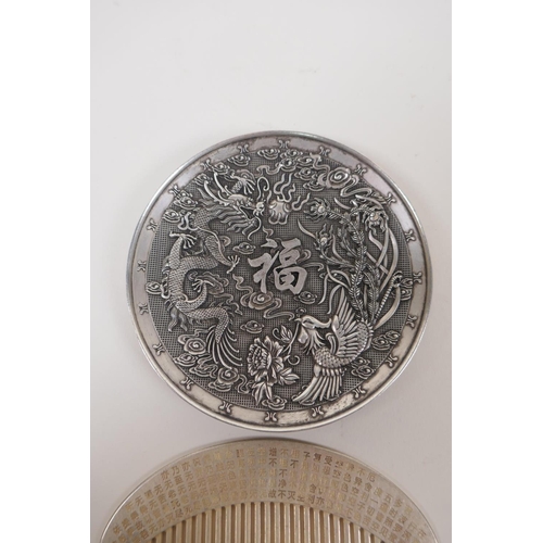 83 - A Chinese white metal trinket dish with raised dragon phoenix and auspicious character decoration, t... 