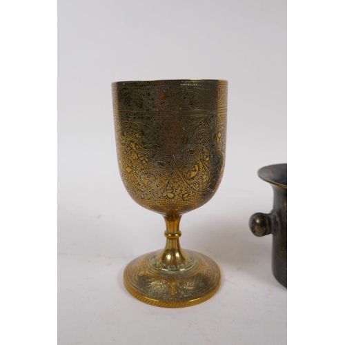 9 - A brass goblet with engraved decoration, a mortar shaped vessel, 10cm high, and a stylised figure of... 