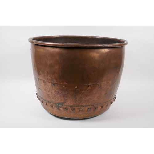 91 - A large antique copper riveted bucket with historic repairs, 31cm high x 42cm diameter