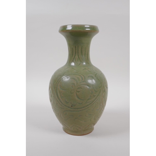 95 - A Chinese olive green glazed porcelain vase with underglaze scrolling floral decoration, 23cm high